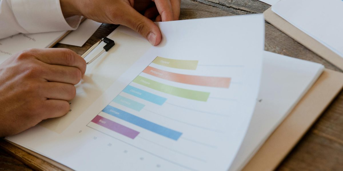 A businessperson analyzing financial reports and data to evaluate the investment potential of a commercial property.