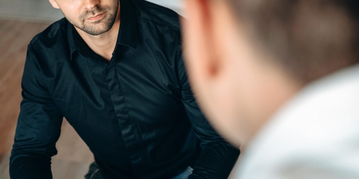 A professional real estate agent offering guidance and honest advice to a client regarding commercial property.