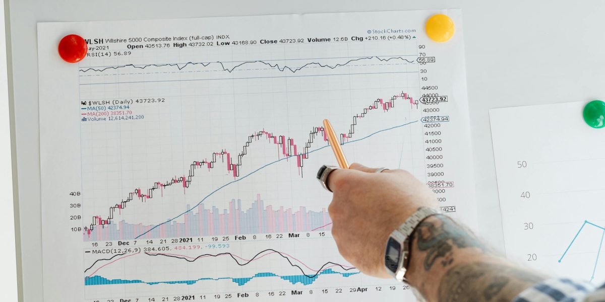 An investor thoughtfully reviewing various options for property investment, considering market stability and growth potential.