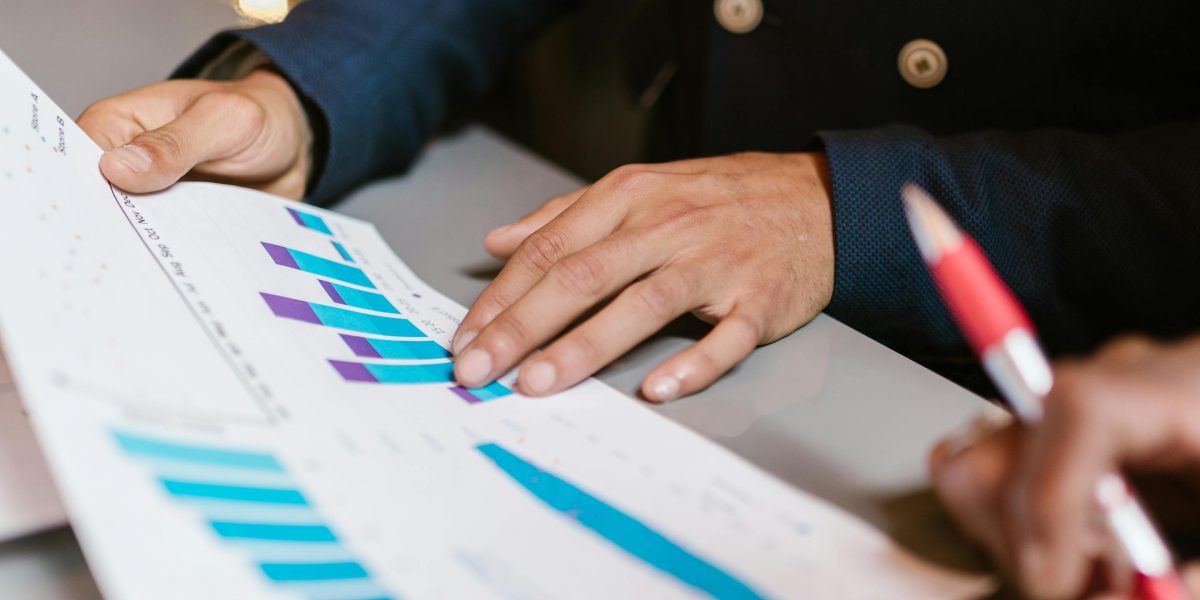 An investor thoughtfully reviewing financial documents, symbolizing the initial phase of identifying and evaluating investment opportunities abroad.