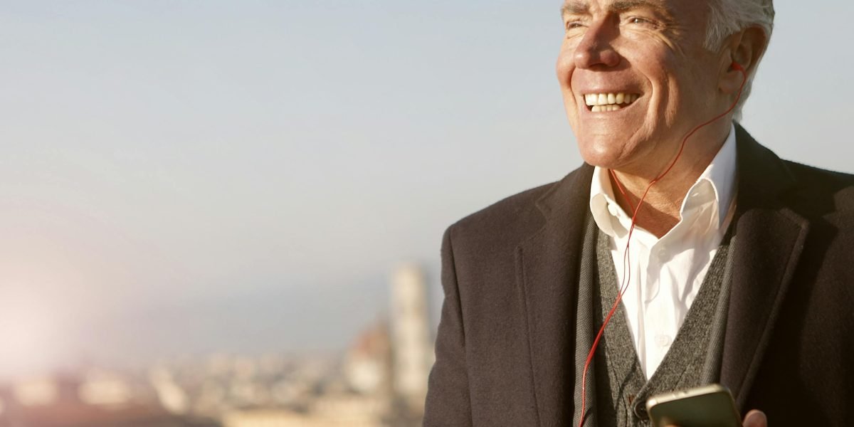 A person with a confident demeanor overlooks a modern cityscape, representing the positive outcomes and growth potential of smart investment decisions.
