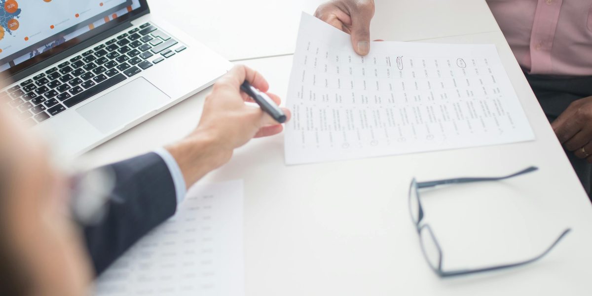 An individual engaging in a focused discussion with a financial advisor, illustrating the importance of expert guidance during complex international property transactions.