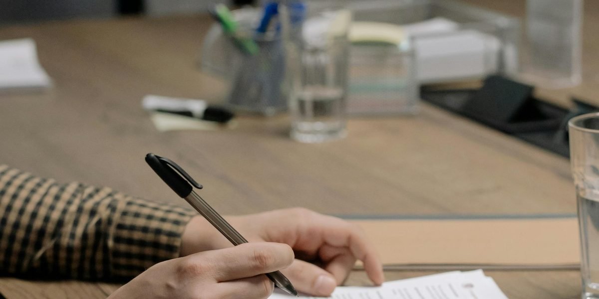 Two individuals meticulously reviewing legal contracts and documents, ensuring compliance.