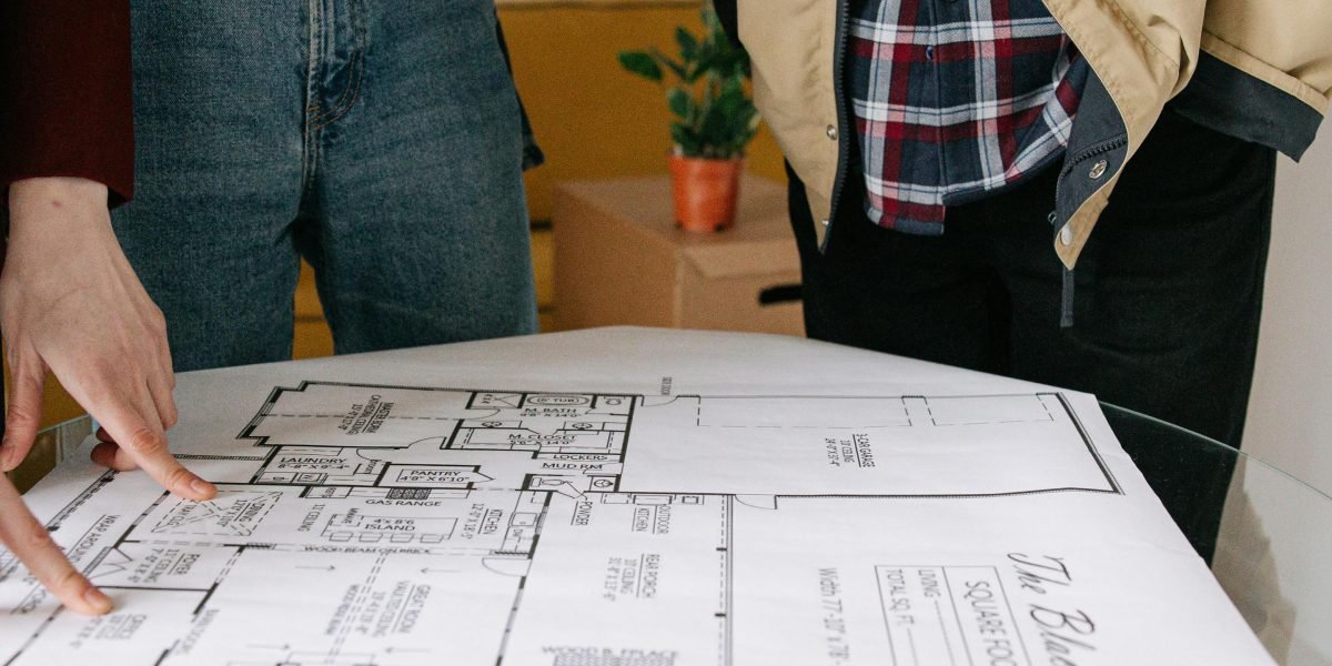 A client consulting with a real estate agent, reviewing important documents.