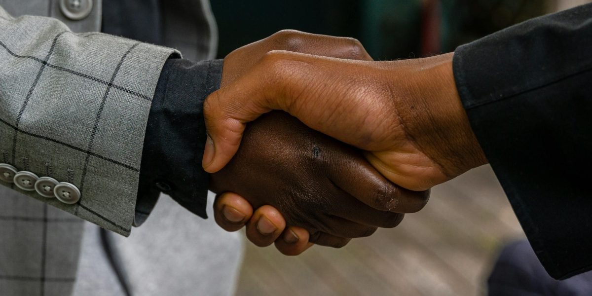 Professionals shaking hands after a successful discussion, symbolizing legal agreement.