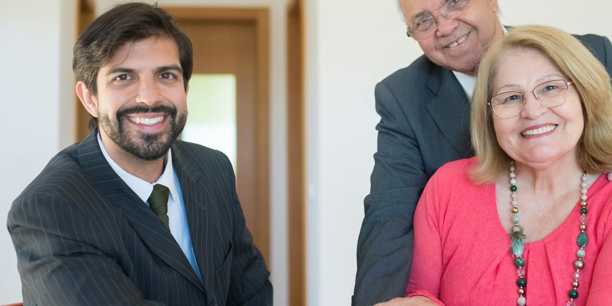 Expats discussing mortgage options and financial planning with an advisor for their Dubai property purchase.