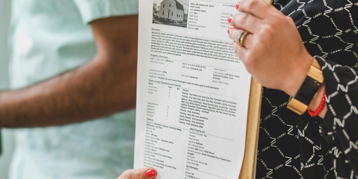 Stock photo suggestion: person reviewing property paperwork and feeling overwhelmed — to humanise the first-step anxiety buyers feel.