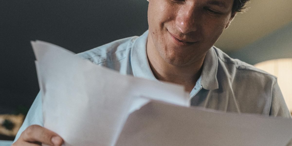 A confident person reviewing documents, illustrating the final stages of making a significant business decision.