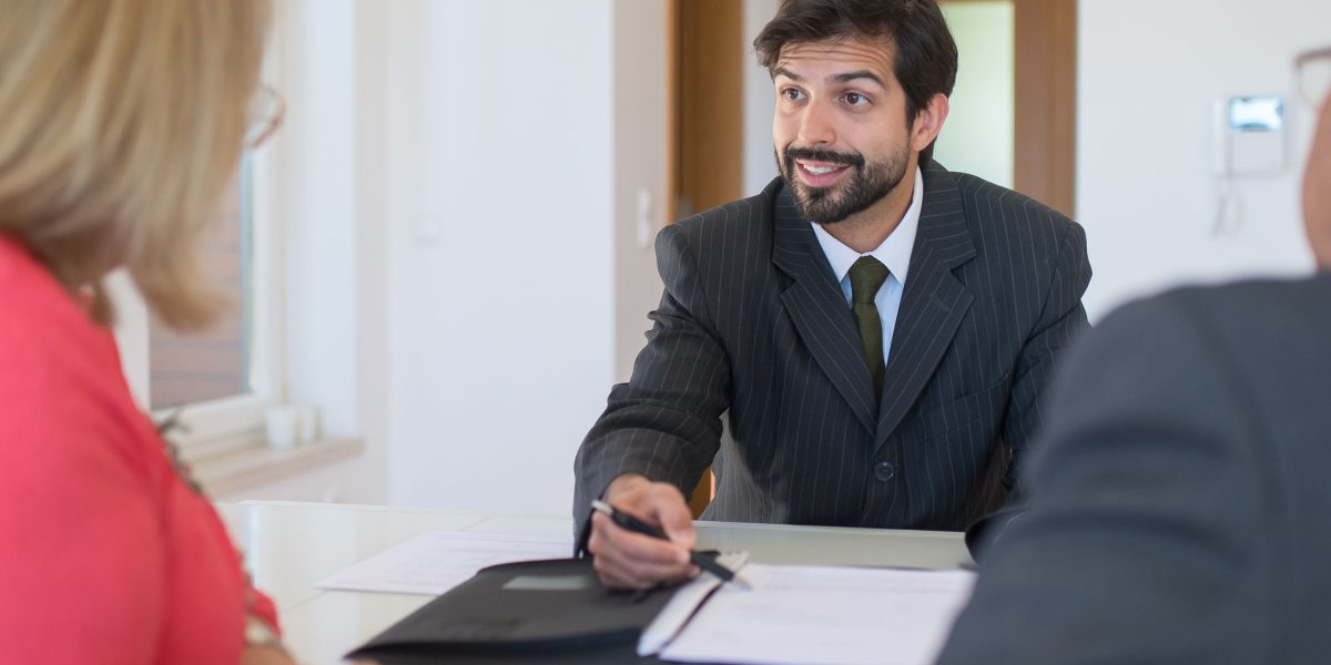 An individual consults with an advisor, reflecting the common need for trusted guidance in navigating a complex real estate market.