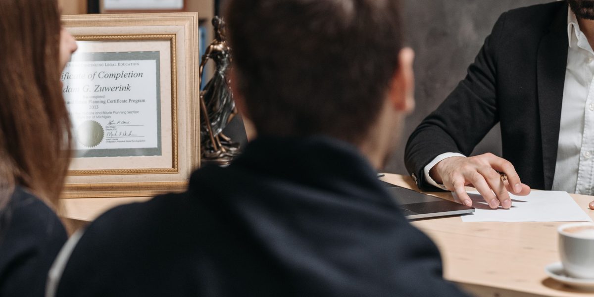 A professional real estate agent engaging in a focused discussion with a client, building trust and clarifying specific needs.