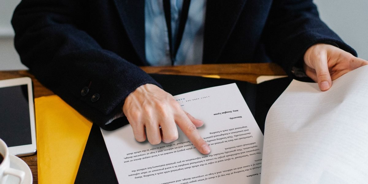 Business professionals review lease documents, illustrating the simplified process facilitated by modern CRE platform tools.
