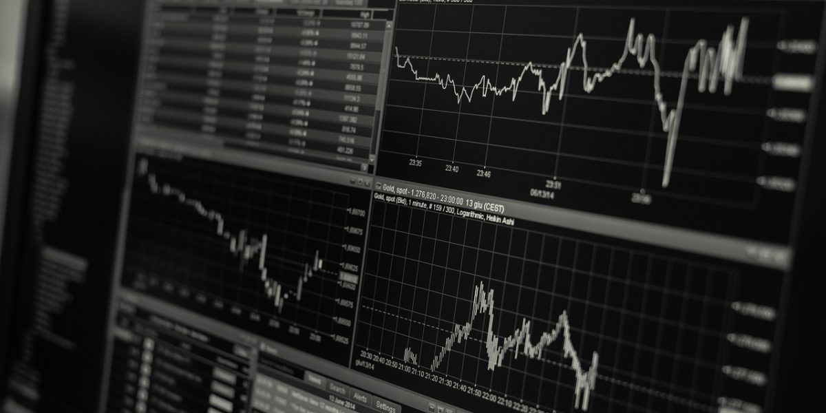 A group of professionals collaboratively analyzing market indicators and financial reports.