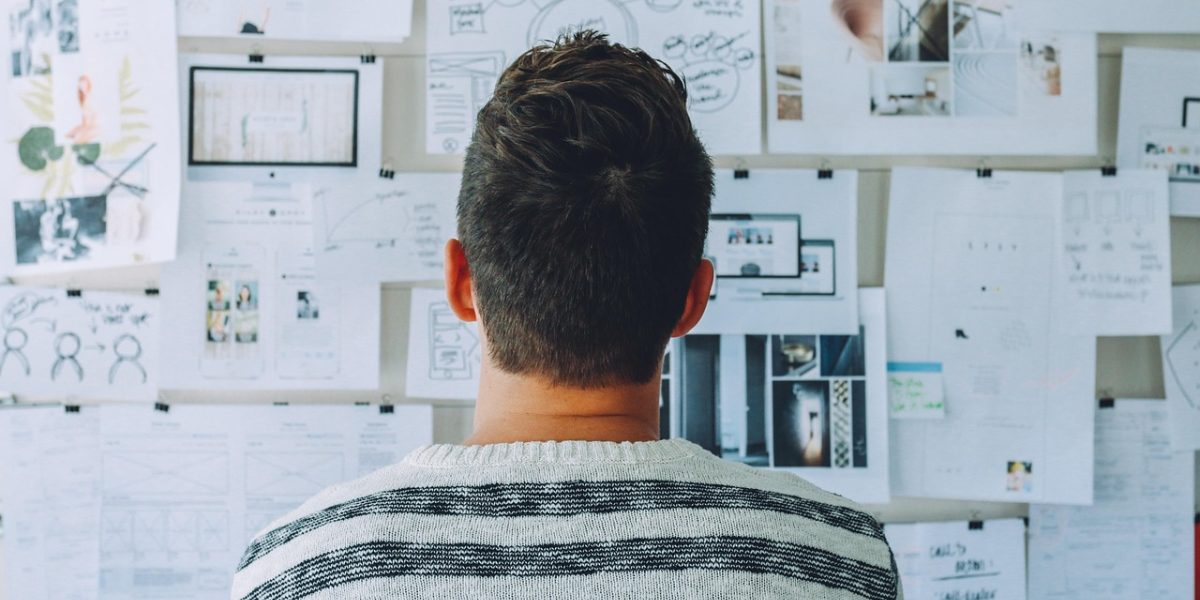 An individual thoughtfully considering market data and regulatory changes for future investment strategies.