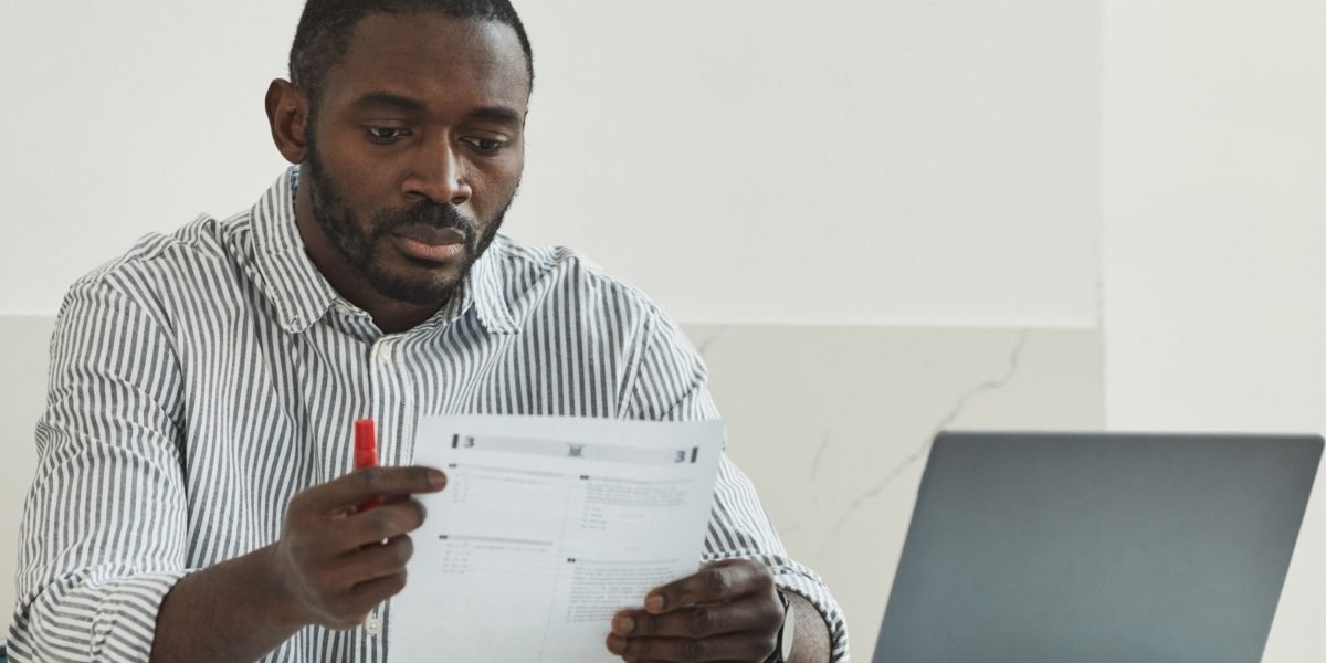 An investor carefully reviews documents, considering different financing options for a commercial property in Dubai.