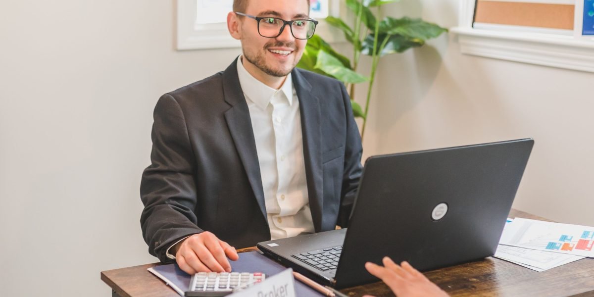 An investor discusses loan offers with a financial advisor, seeking expert guidance on commercial property financing.