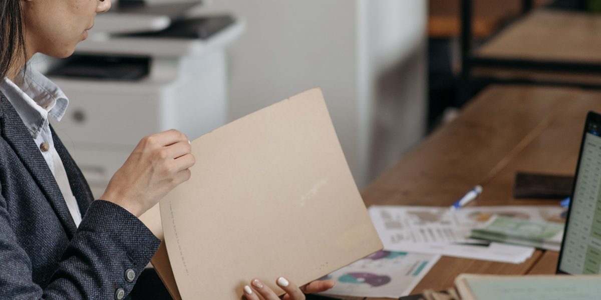 A professional meticulously reviewing financial documents, reflecting careful planning and smart investment decisions.