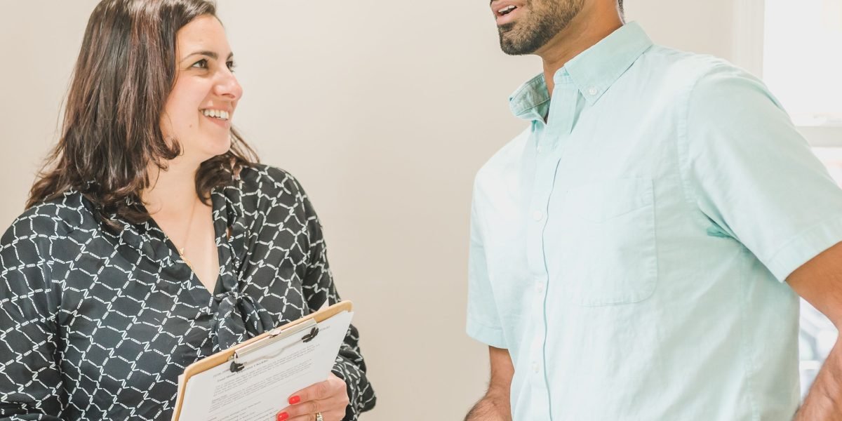 A real estate agent engaging in a focused discussion with a client, building trust and offering expert guidance.