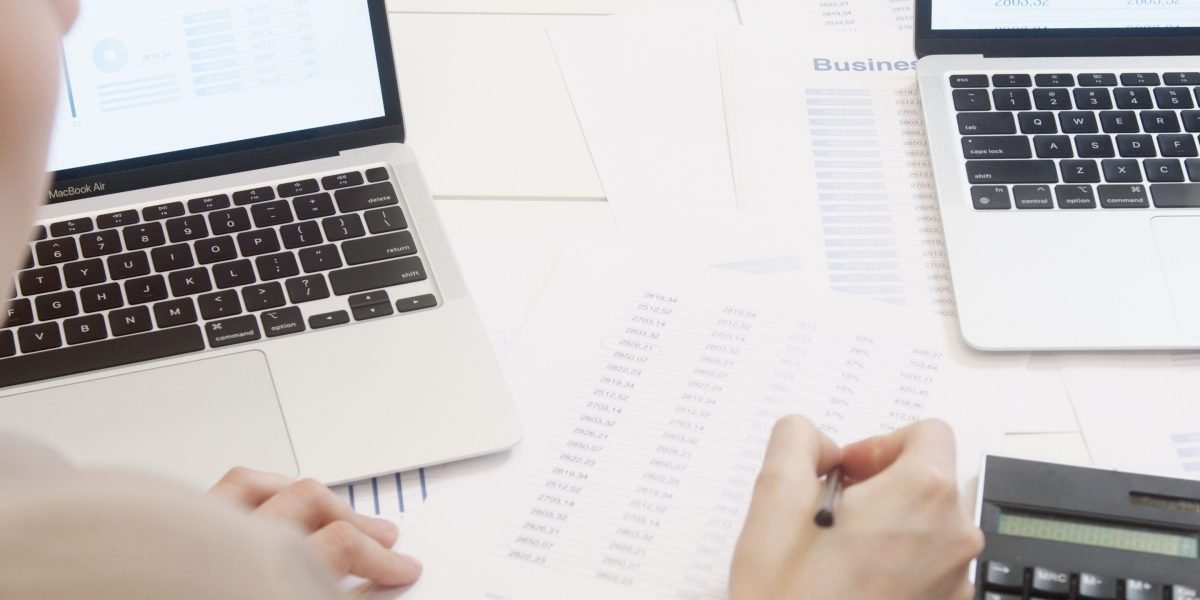 A person focused on financial calculations, working to determine the true effective cost of a commercial loan.