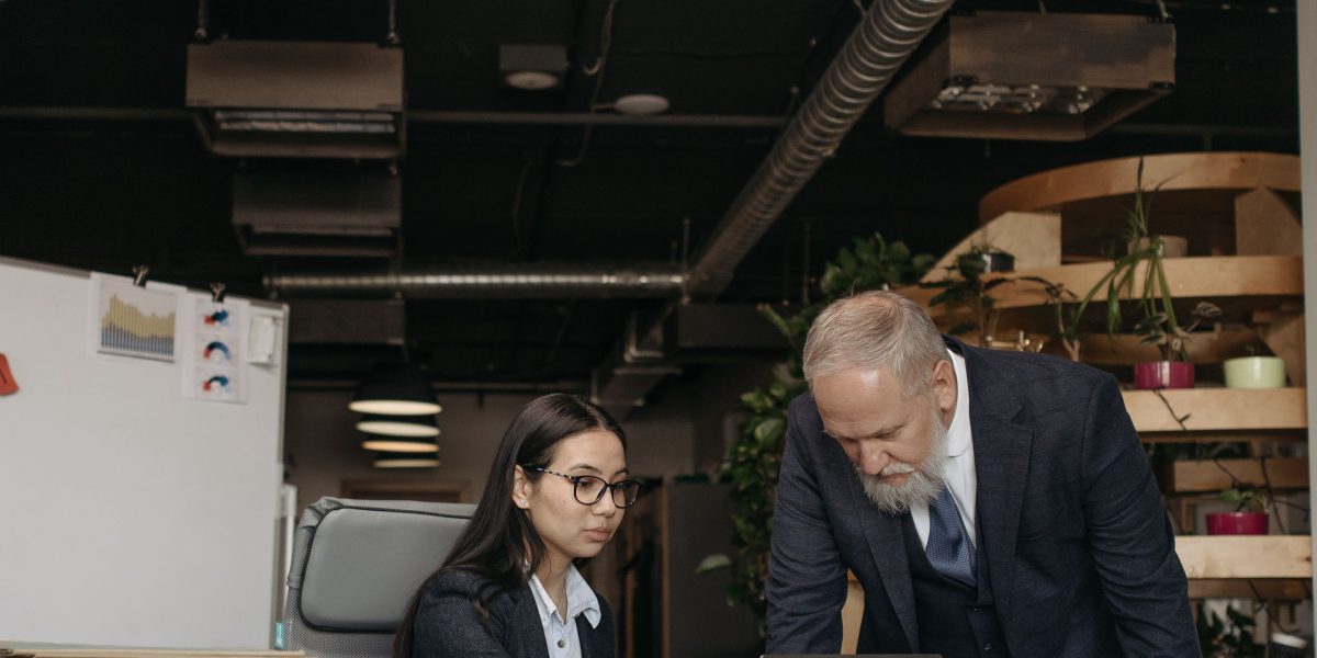 An experienced professional guiding a new employee, symbolizing career growth and mentorship in commercial real estate.