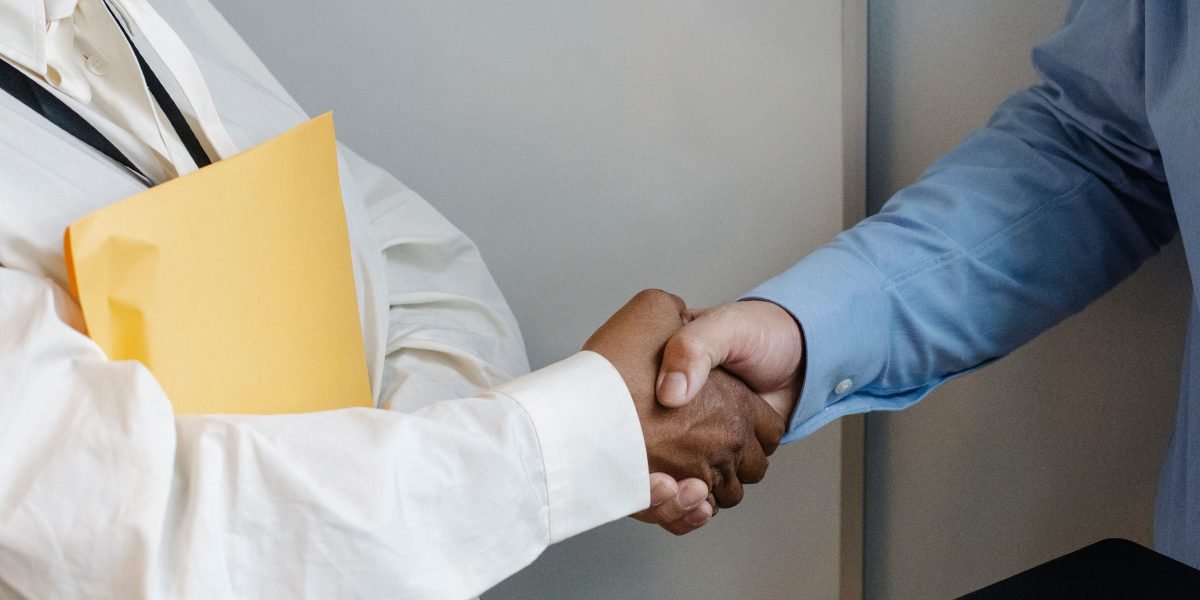 Two professionals shaking hands, symbolizing the establishment of a trusted partnership in commercial real estate.