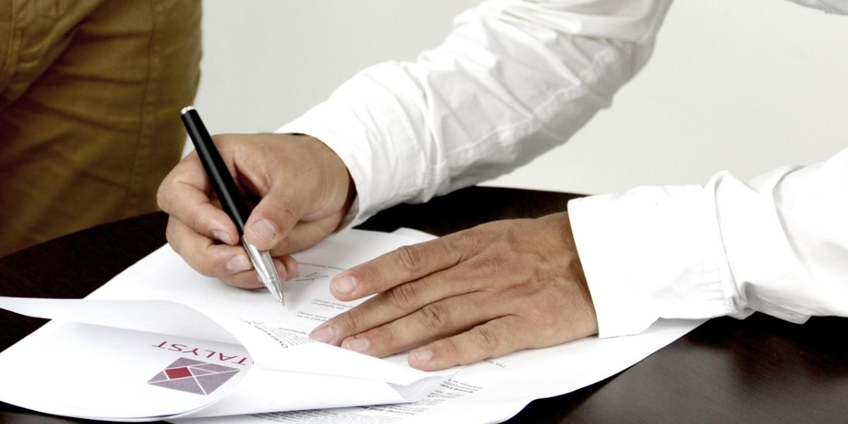 A professional carefully reviewing legal documents related to a commercial lease.